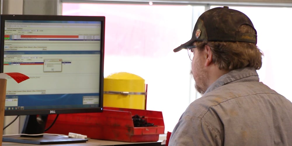 Man-Working-on-Computer-in-Maintenance-Shop